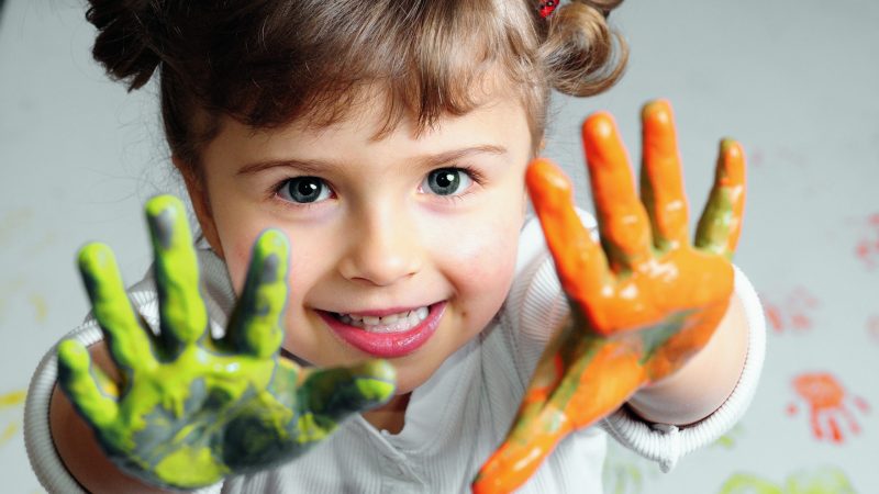 Little girl playing with colors